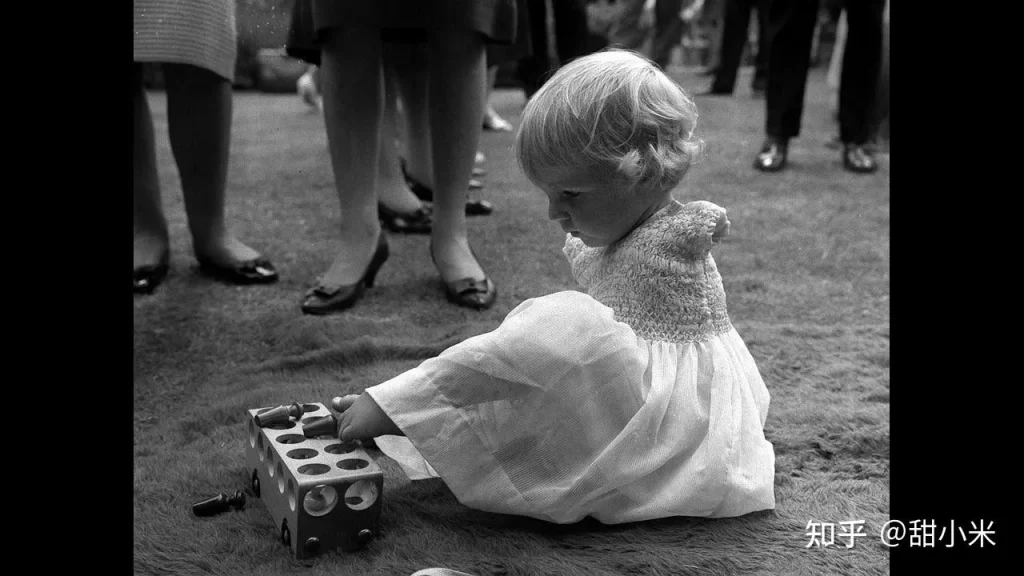 サリドマイド薬害の被害を受けた女の子、手がなく足の指でおもちゃで遊ぶ白黒写真