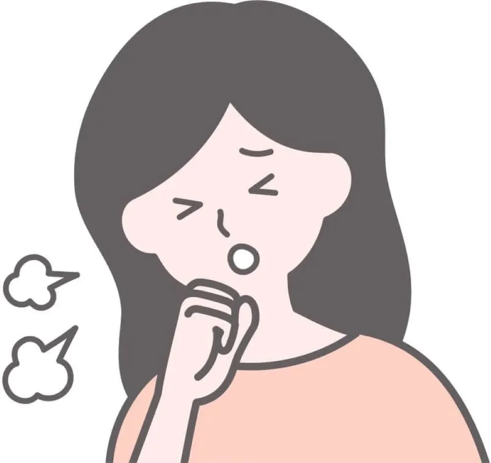 ピンク色の服を着た女性が右手を口元に当てて咳をしているイラスト。横に咳の雲が描かれている
