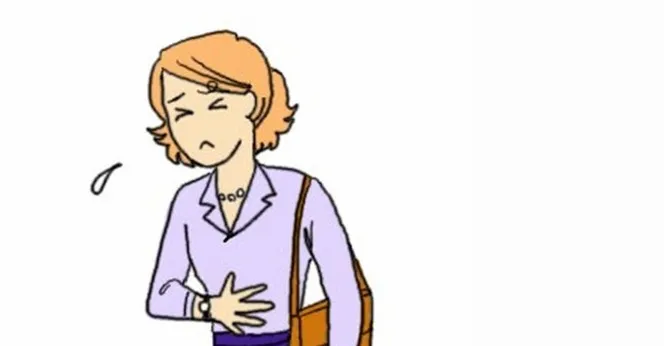女性が腹痛で胃を押さえている様子