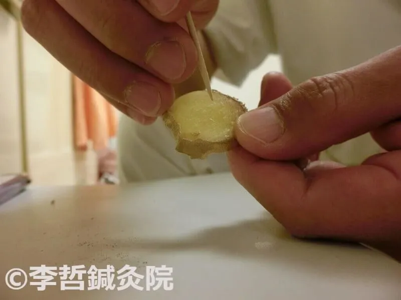 生姜灸で台の生姜につまようじで5〜10個の穴を開ける作業